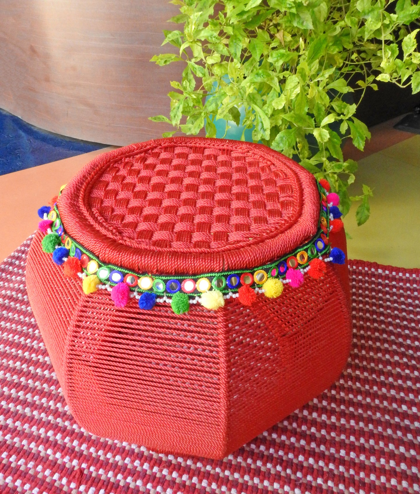 red-bamboo-pouffe-with-colourful-pompoms
